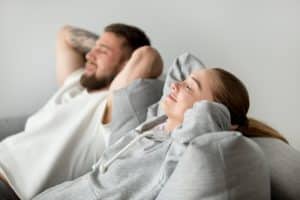 couple resting on comfortable sofa